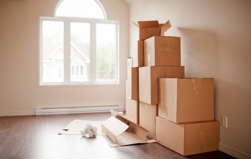 Professional movers carrying furniture during a Dollis Hill relocation