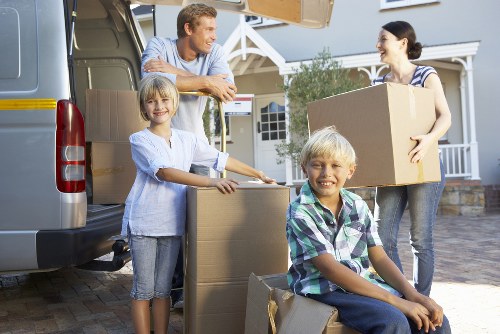 Removal team preparing a flat move in Dollishill with boxes and furniture